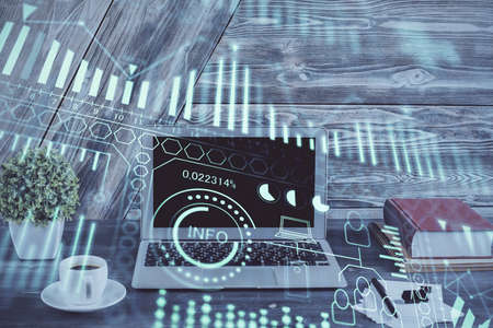 Computer on desktop in office with technology theme hologram. Double exposure. Tech concept.