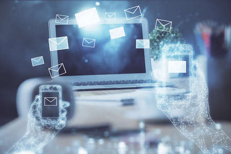 Desktop computer background in office and flying envelops hologram drawing. Multi exposure....