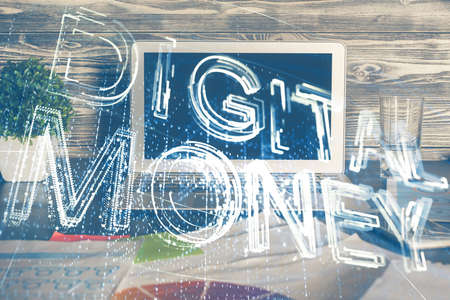 Multi exposure of blockchain theme hologram and table with computer background. Concept of bitcoin crypto currency.の写真素材