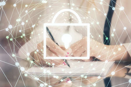 Double exposure of hands making notes with lock icons. Concept security and protection of dataの写真素材