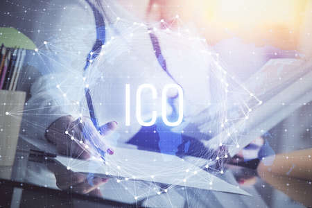 Cryptocurrency hologram over womans hands writing background. Concept of blockchain. Double exposureの写真素材