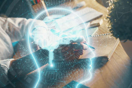Multi exposure of writing hand on background with brain hologram. Concept of self learning.の写真素材