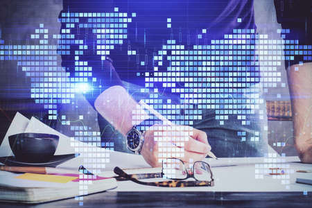 Double exposure of hands and notepad with business icons. Concept of international business.