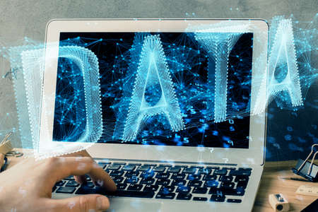 Double exposure of data internet theme hologram with man working on computer on background. Concept...