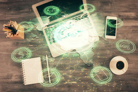 Social network hologram drawings over computer on the desktop background. Top view. Multi exposure....