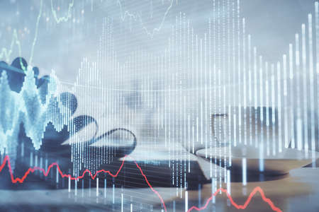 Double exposure of financial chart drawing and desktop with coffee and items on table background....