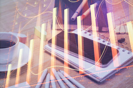 Double exposure of forex chart drawing and cell phone background. Concept of financial tradingの写真素材