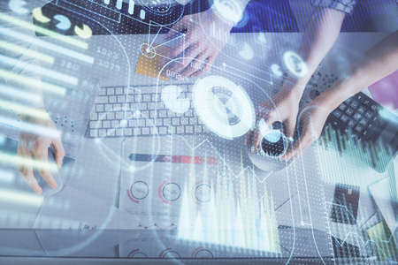 Double exposure of man and woman working together and data theme hologram drawing. Computer...