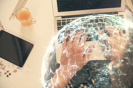 Double exposure of mans hands typing over computer keyboard and social network theme hologram...