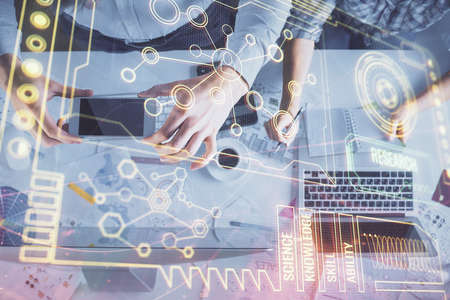 Double exposure of man and woman working together and data theme hologram drawing. Computer...