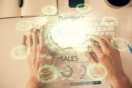Double exposure of mans hands typing over computer keyboard and social network theme hologram drawing. Top view. People connection web concept.の写真素材