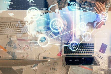 Double exposure of man and woman working together and social network theme hologram drawing....