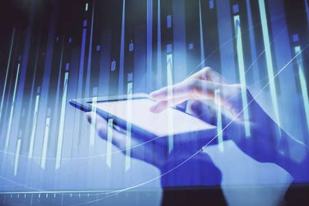 Double exposure of forex chart sketch hologram and woman holding and using a mobile device....
