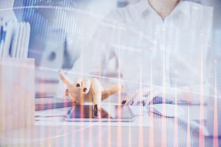 Double exposure of forex chart sketch hologram and woman holding and using a mobile device....
