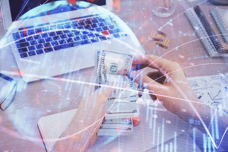 Multi exposure of financial graph drawing hologram and USA dollars bills and man hands. Analysis...