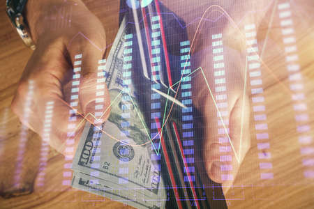 Multi exposure of forex graph drawing hologram and USA dollars bills and man hands. Technical Analysis concept.の写真素材