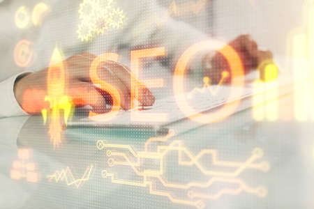 Multi exposure of seo icon with man working on computer on background. Concept of search engine...