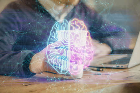 Businessman with computer background with brain theme hologram. Concept of brainstorm. Multi...