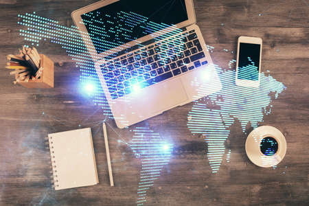 Social network hologram drawings over computer on the desktop background. Top view. Multi exposure. Concept of people connection.の写真素材