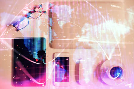 Double exposure of business theme hologram over desktop with phone. Top view. Mobile international trade connection concept.の写真素材