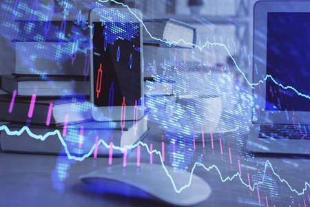 Double exposure of financial graph drawing and cell phone background. Concept of forex tradingの写真素材