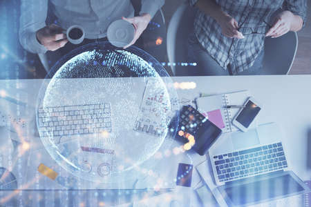 Double exposure of man and woman working together and world map hologram drawing. international network concept. Computer background. Top View.の写真素材