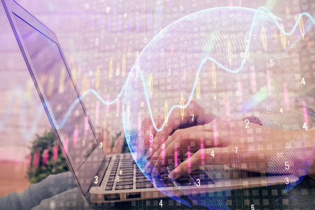 Multi exposure of woman hands typing on computer and forex chart hologram drawing. Stock market...
