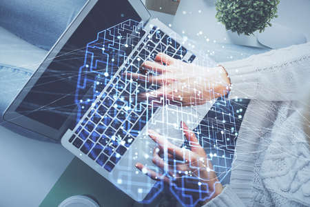 Double exposure of woman working on computer andhuman brain hologram drawing. Top View. Ai concept.