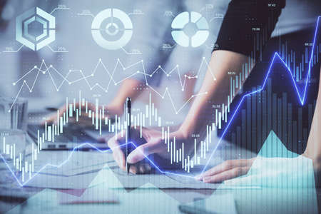 Multi exposure of woman hands typing on computer and financial chart hologram drawing. Stock market...