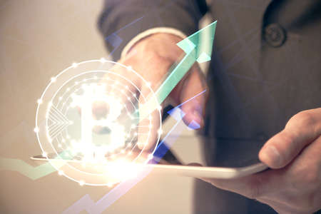 Double exposure of mans hands holding and using a phone and crypto currency blockchain theme drawing.の写真素材