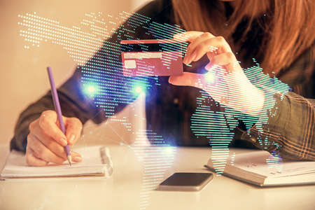 Multi exposure of woman on-line shopping holding a credit card and social network theme drawing....