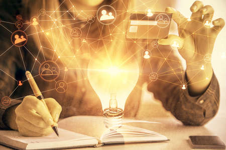 Multi exposure of woman on-line shopping holding a credit card and social network theme drawing. Relationship E-commerce concept.の写真素材