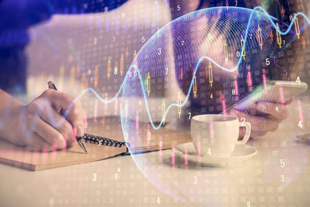 Double exposure of forex graph sketch hologram and woman holding and using a mobile device. Stock...