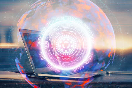 Computer on desktop in office with technology theme hologram. Multi exposure. Tech concept.の写真素材