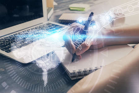 Multi exposure of writing hand on background with brain hologram. Concept of learning.