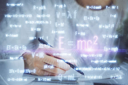 Science formula hologram over womans hands taking notes background. Concept of study. Double exposureの写真素材