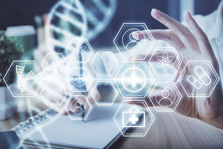 DNA theme hologram over womans hands writing background. Concept of education. Double exposure