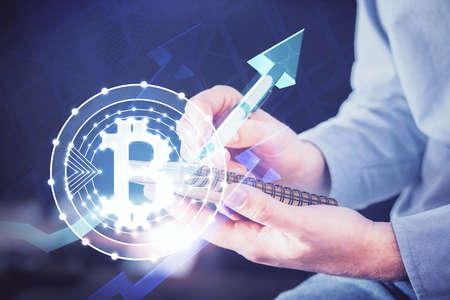 Mans hands working with notes background. Cryptocurrency and finance concept. Double exposure.