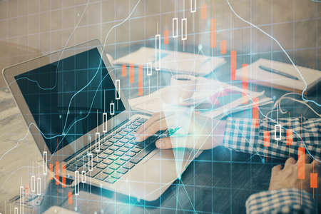 Double exposure of forex chart with man working on computer on background. Concept of market...