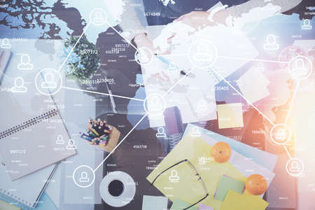 Social network theme hologram over hands taking notes background. Concept of global international...