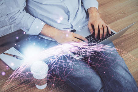 Media network theme hologram with man working on computer on background. Concept of internet...