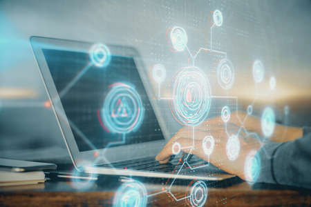 A man working on Laptop with technology theme drawing. Concept of big data. Double exposure.