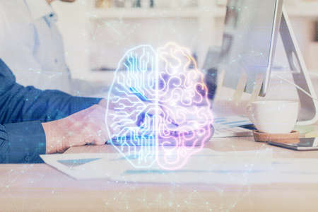 Businessman with computer background with brain theme hologram. Concept of brainstorm. Multi exposure.の写真素材