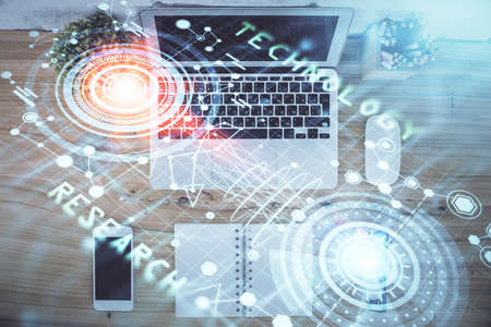 Double exposure of data theme drawing hologram over topview work table background with computer....