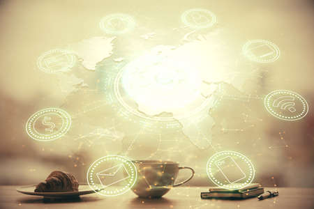 Double exposure of social network theme drawing hologram over coffee cup background in office....