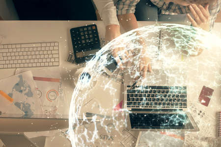 Double exposure of man and woman working together and social network theme hologram drawing. Computer background. connecting concept. Top View.の写真素材