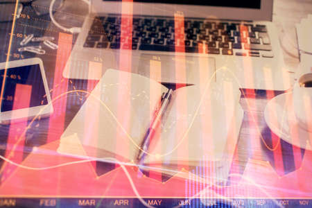 Multi exposure of financial graph drawings and desk with open notebook background. Concept of forex