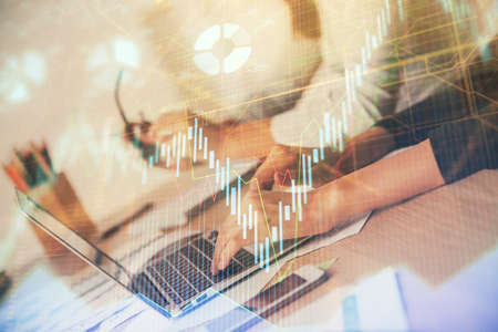 Multi exposure of woman hands typing on computer and financial chart hologram drawing. Stock market...