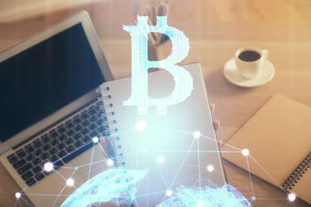 Double exposure of woman hands typing on computer and crypto market theme hologram drawing....