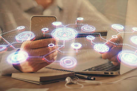 Double exposure of man hands holding a credit card and social network theme drawing. Digital finance and E-commerce concept.の写真素材